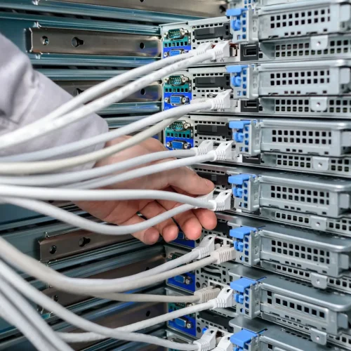Man data center technician performing server maintenance